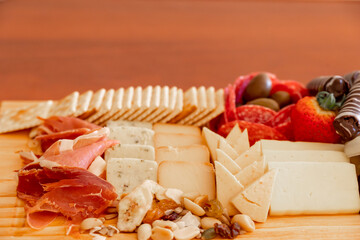 Small cheese table with serrano ham, cookies, olives and nuts