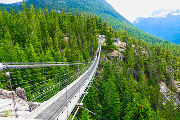 Squamish, BC, Canada - June 24, 2019: Sky Pilot Suspension Bridge, Walk on the suspension bridge and enjoy the wide view. It goes both up to the mountains above and down to Howe Sound below. © twabian