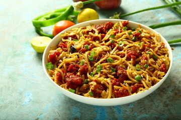 Bowl of delicious chicken noodles cooked with exotic spices and herbs- Asian street foods.