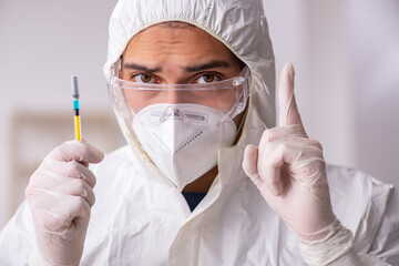 Young male chemist in vaccination concept during pandemic