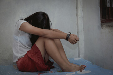 Kidnapped girl tied with leather belt.Abused and tortured concept. Human trafficking concept.