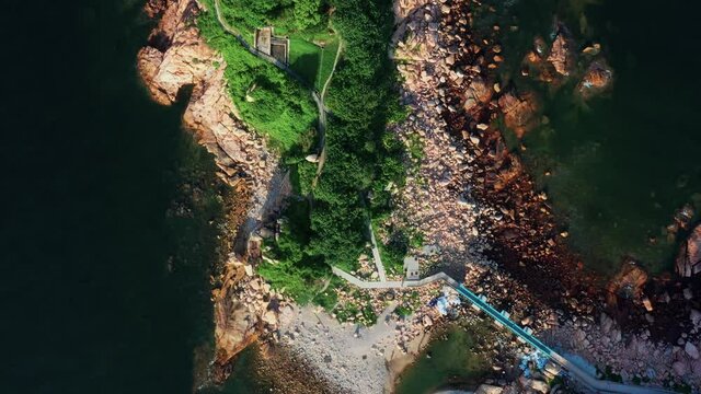Aerial view during flyover around the Shek-O beach shore area in Hong Kong Peninsular. Aerial, beautiful seascape and a view on a small islands. 
