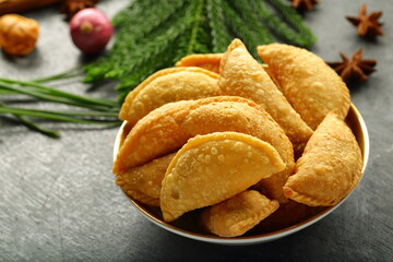 Bowl of delicious curry puff pastry served on a holiday background.