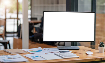 Naklejka premium Close up view of simple workspace with open blank screen laptop, frame and notebook on white table with blurred office room background