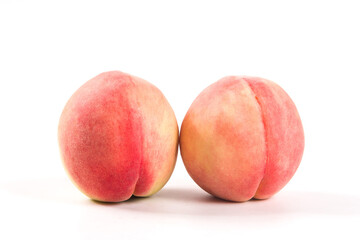 Ripe peachs fruit close-up on white background