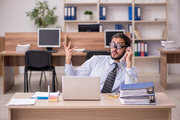 Young funny businessman employee working at workplace