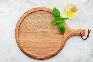 Empty wooden pizza platter set up on white concrete. Pizza tray on white concrete background flat lay and copy space..