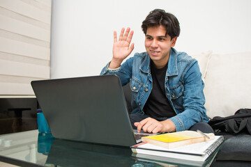 young latin student taking a virtual class on his laptop
