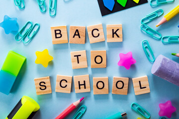 Stationery and lettering back to school in english, blue background