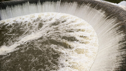 water cascade streaming down a lasher, cool white balance, concept for water saving, conservation,...