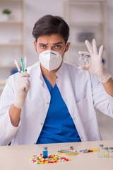 Young male doctor in vaccination concept
