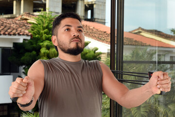 man practicing exercise, with chest expander,