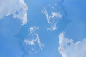 Soft white clouds and blue sky background.