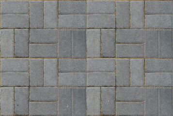 Seamless texture of a pedestrian path paved with artificial gray stone.