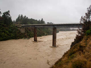 Heavy rain up in the Canterbury headwaters causes the Waimakariri River to flood and the muddy...