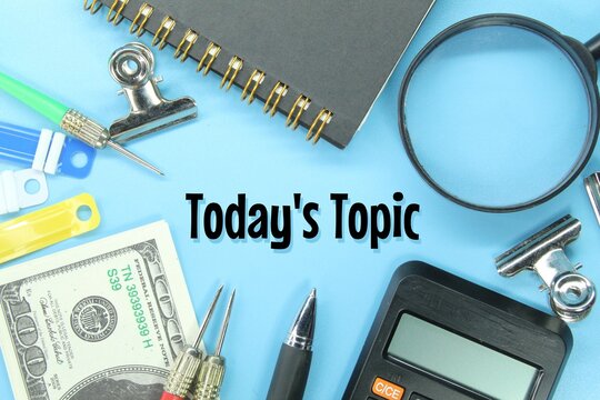 calculators, banknotes, pens, notebooks, clamps with today’s topic words