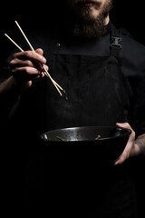 Chef holding a bowl with freshly made soup