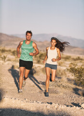 Runners couple running long distance ultra trail run race. Runner man and sport woman training...