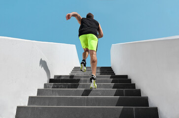 Stairs exercise fitess man running fast up the staircase for hiit cardio workout run at outdoor...