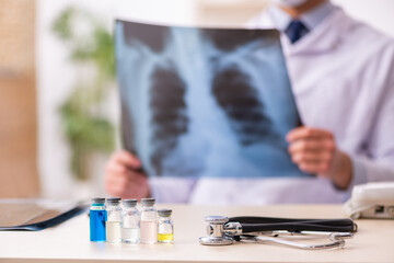 Young male doctor radiologist working in the clinic during pande