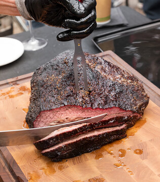 Chef carving a portion of succulent beef brisket