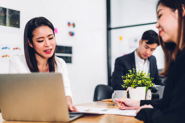 Group of professional success asian business meeting and discussing strategy with new startup project.Creative business people planning and brainstorm with laptop computer in modern office.Teamwork 