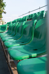 Close up of empty green stadium plastic seats in a sport arena.