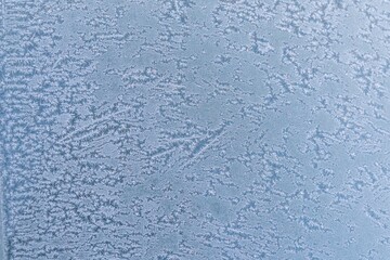 Selective focus. First frost on a frozen car, late autumn close-up. Beautiful abstract frozen microcosmos pattern. Freezing weather frost action in nature. Winter backdrop.