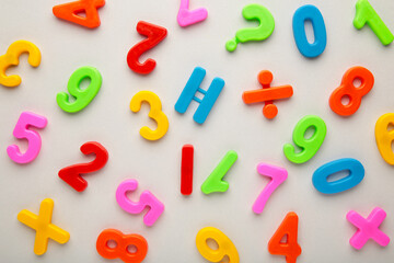 Many colorful numbers on grey background with copy space.