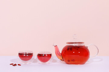 glass of glass of goji berry  tea and teapot