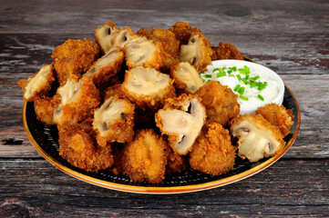 Whole breaded button mushrooms with soured cream and chive dip