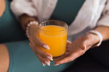 fresh ogange juice in woman's hands