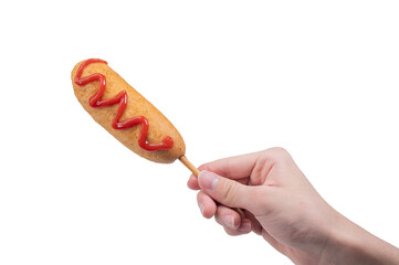 hand holding corn dog isolated on white background