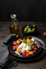 Burrata cheese with tomatoes and olives. Caprese salad with mozzarella 