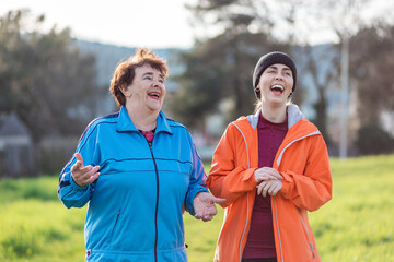 Naklejka premium Happy grandmother and adult granddaughter have fun talking. Family time. Outdoor. International Day of Older Persons