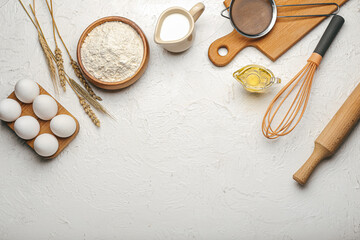 Fototapeta na wymiar Ingredients for preparing bakery and utensils on light background