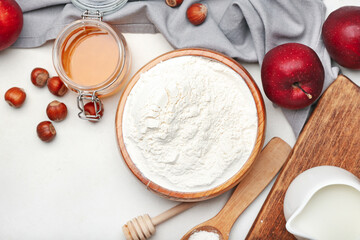 Ingredients for preparing bakery, apple and nuts on light background