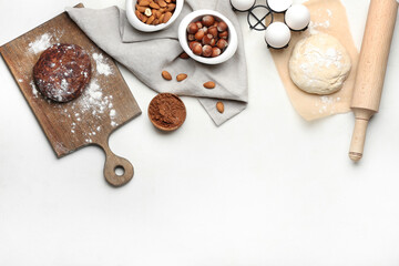 Fototapeta na wymiar Fresh dough with ingredients for preparing bakery and utensils on light background