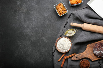 Fototapeta na wymiar Ingredients for preparing bakery and utensils on dark background