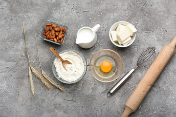 Ingredients for preparing bakery and utensils on grey background
