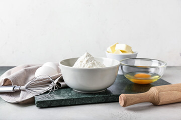 Ingredients for preparing bakery and utensils on light background