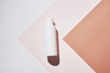 Natural cosmetics mock up. Beauty product concept. White bottle on pastel background