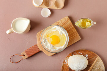Ingredients for preparing bakery and utensils on color background