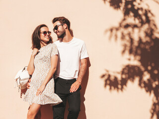 Portrait of smiling beautiful woman and her handsome boyfriend. Woman in casual summer clothes....