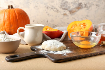 Ingredients for preparing bakery with pumpkin on color background