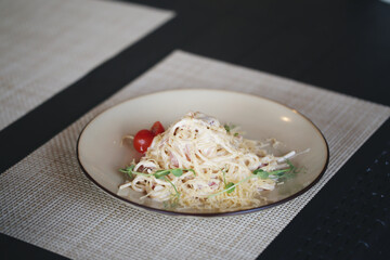 pasta carbonara in a plate is on the table