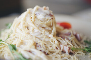 pasta carbonara in a plate is on the table