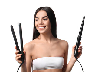 Fototapeta premium Beautiful young woman with flattening and curling irons on white background