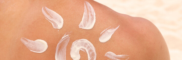 Sun shaped sunscreen is applied to male back