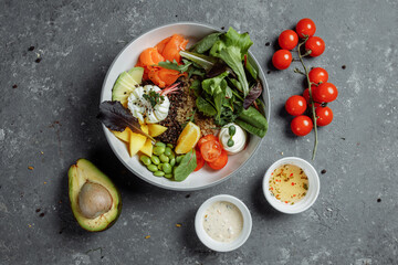 Fototapeta na wymiar fresh healthy light breakfast, business lunch. Breakfast with poached egg, buckwheat, red fish, fresh salad, cucumbers, business lunch concept